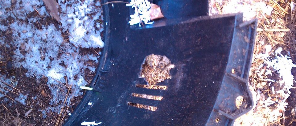 Rodent damage on bottom section of compost bin.